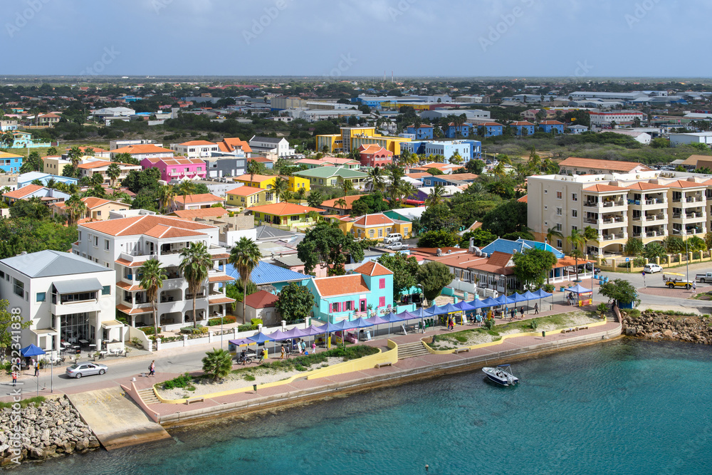 Aerial view of the waterfront coastal tropical city with bright houses with tiled roof