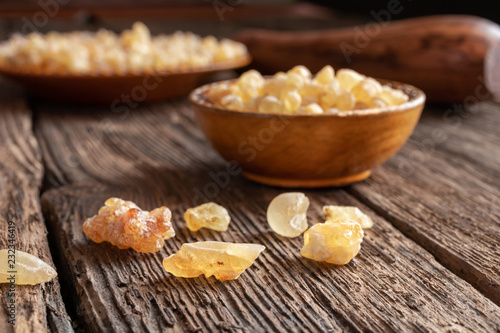 Frankincense resin crystals on a wooden background