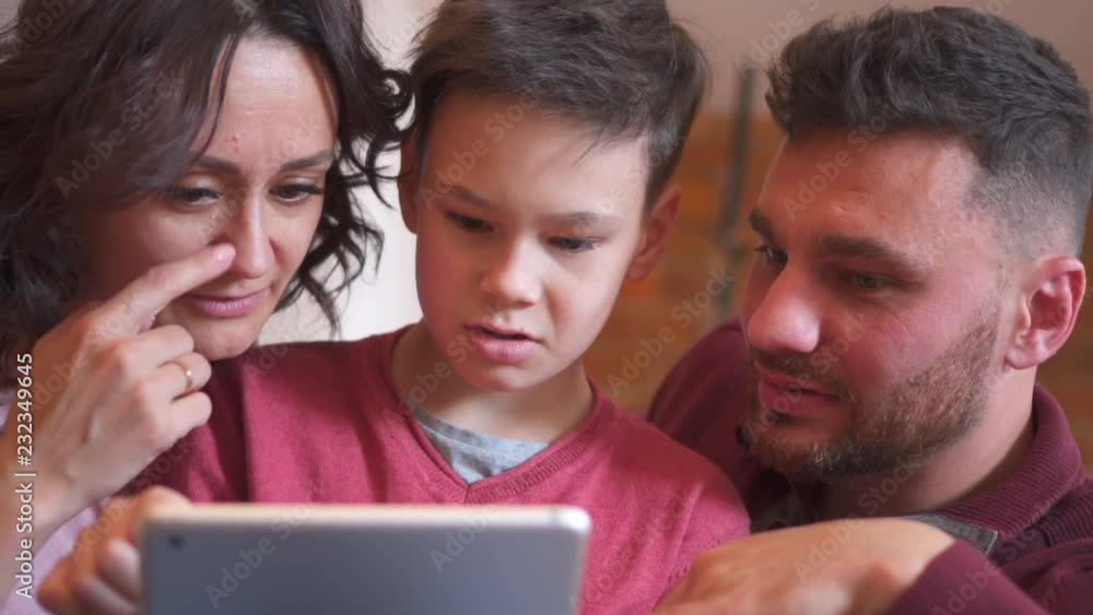 Family playing game on digital tablet Family playing game on digital tablet