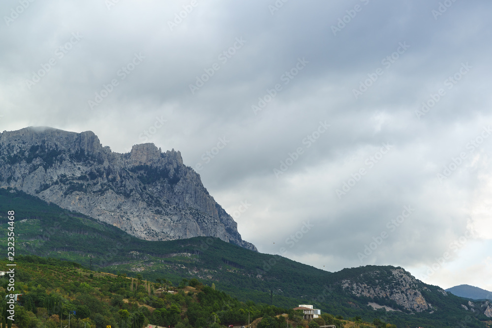 The jags of AI-Petri mountain above the village of Alupka. Grey day on the southern coast of Crimea