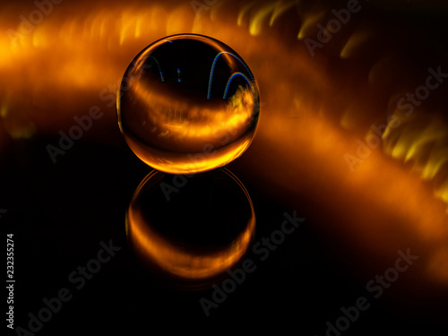 The fire is engulfing the lens ball from behind.