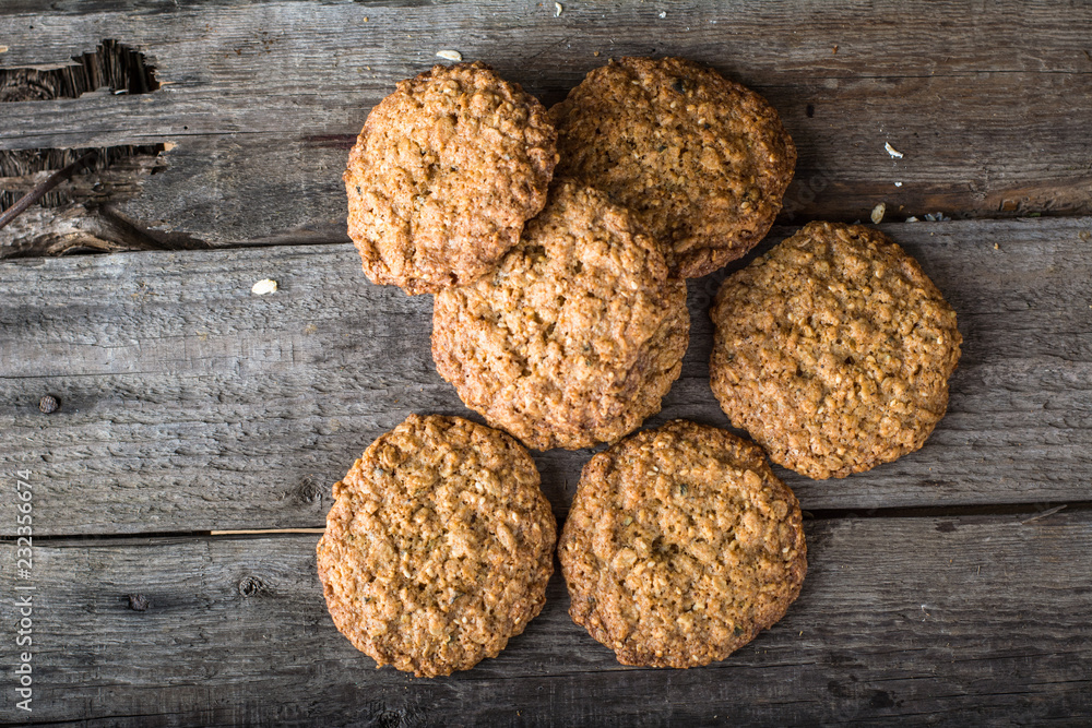 Homemade oatmeal cookies on wooden board on old table background. Healthy Food Snack Concept. Copy space. Milk and cookies. Still life of food. Christmas cookies. Healthy food. Breakfast concept. Homemade oatmeal cookies on wooden board on old table background. Healthy Food Snack Concept. Copy space. Milk and cookies. Still life of food. Christmas cookies. Healthy food. Breakfast concept.