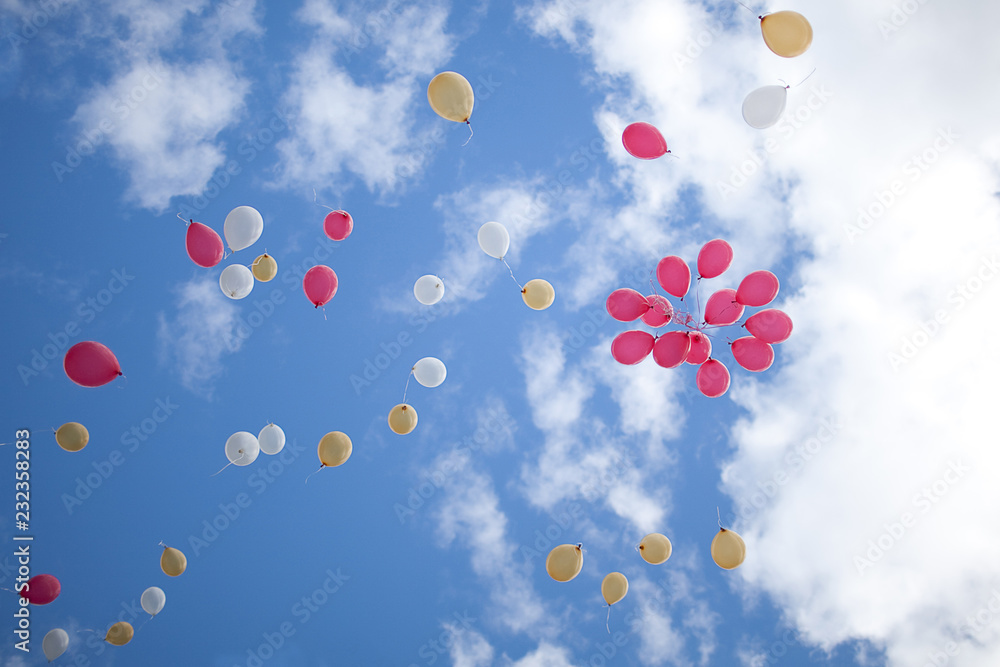 Balls of different colors in the sky with clouds Balls of different colors in the sky with clouds