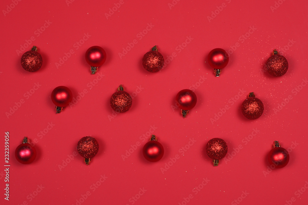 Red Christmas Baubles on red background.