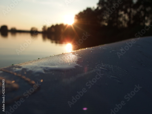 detail canoe on a pond at sunset