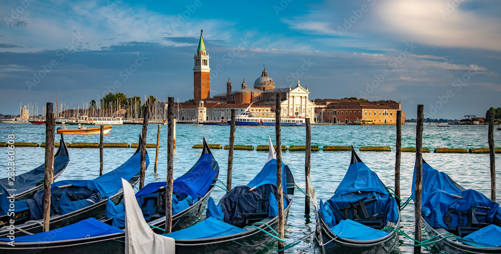 Italy beauty, gondolas parking in Venice, San Giorgio Maggiore behind, Venezia
