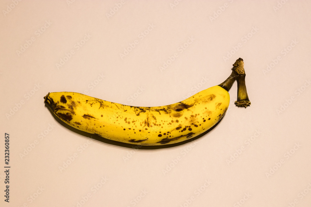 One ripe banana isolated on powdery background. pastel background