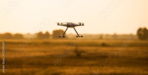 Flying drone in flight over a beautiful meadow 