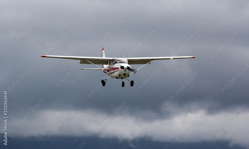 Fototapeta premium Small plane flying on dark sky