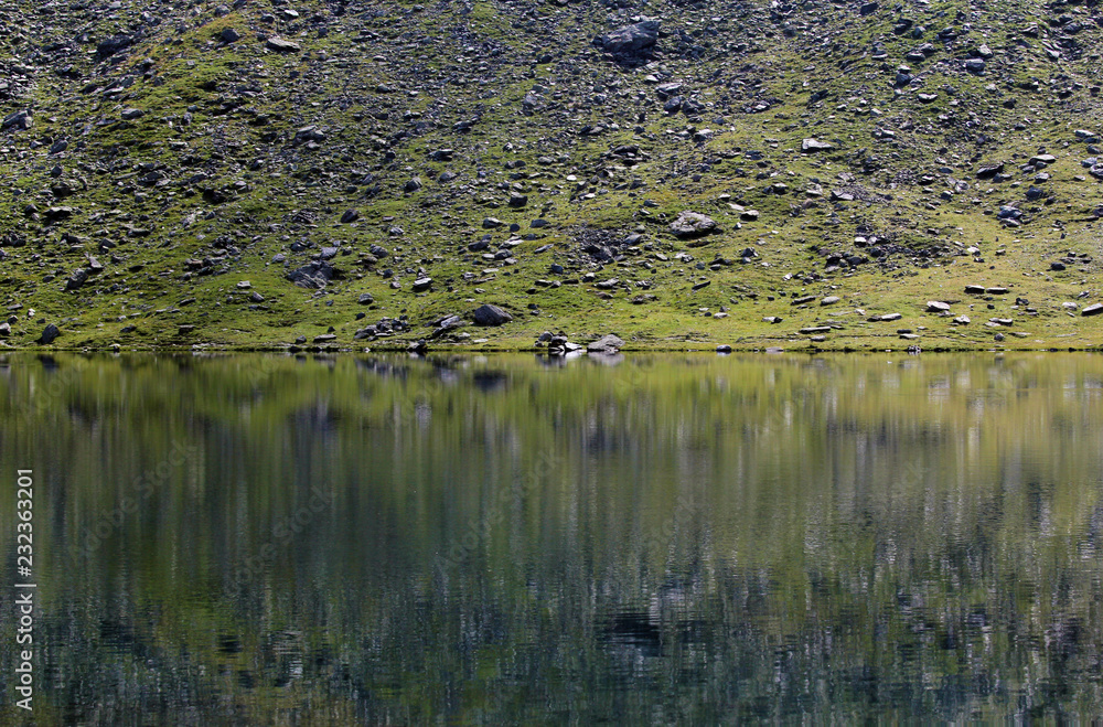Fagaras mountains mirrored in Balea alpine glacial lake Fagaras mountains mirrored in Balea alpine glacial lake