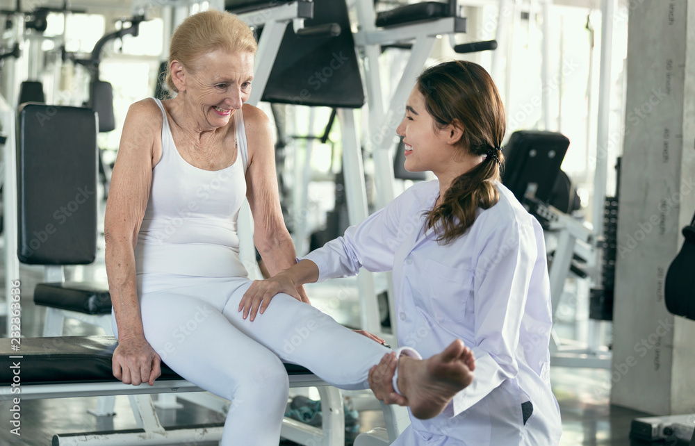 Physiotherapist helping old senior woman in physical center. elderly health lifestyle concept.