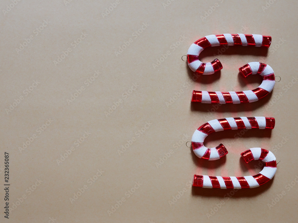 Christmas candy cane drums at studio above view over a brown cream neutral background isolated flatlay Christmas candy cane drums at studio above view over a brown cream neutral background isolated flatlay