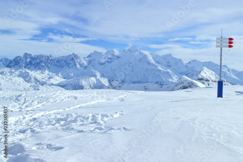 Snowy mountain tops panorama, skiing and snowboarding slopes in French resort of Grand Massif . © Yols