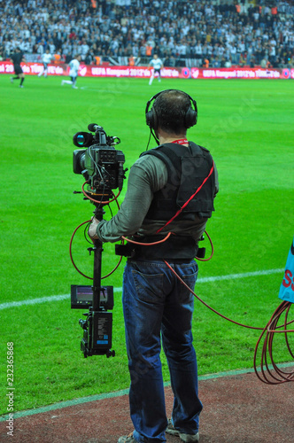 An unknown sports cameraman recording to the competition.