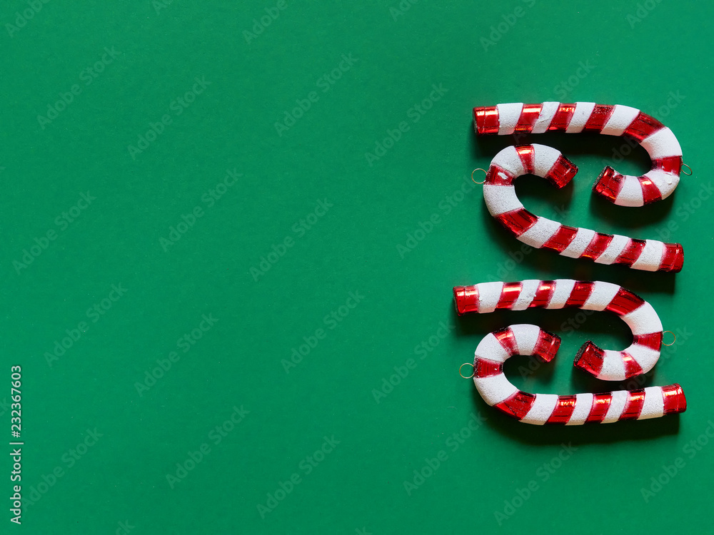 Christmas candy cane drums at studio above view over a green background isolated flatlay Christmas candy cane drums at studio above view over a green background isolated flatlay