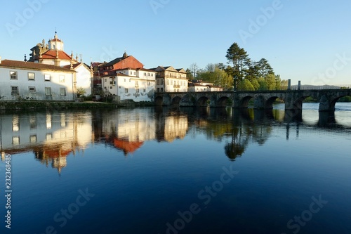Bridge and buildings reflected in river