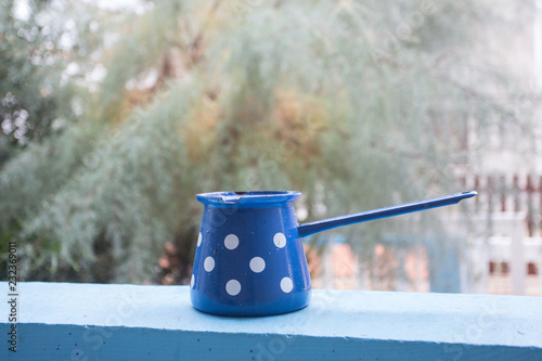 Old fashioned coffee mug on the blue background