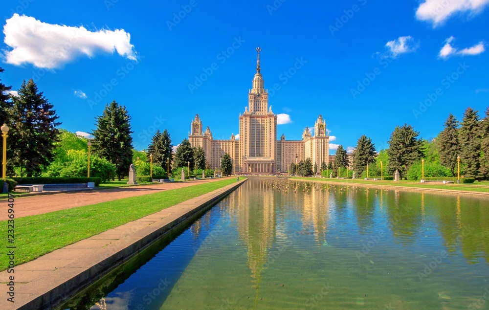 Reflections of main building of famous Russian university in fountain cascade pool in sunny summer