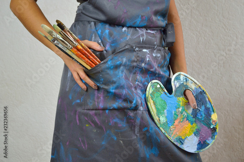 Artist with brushes and color palette