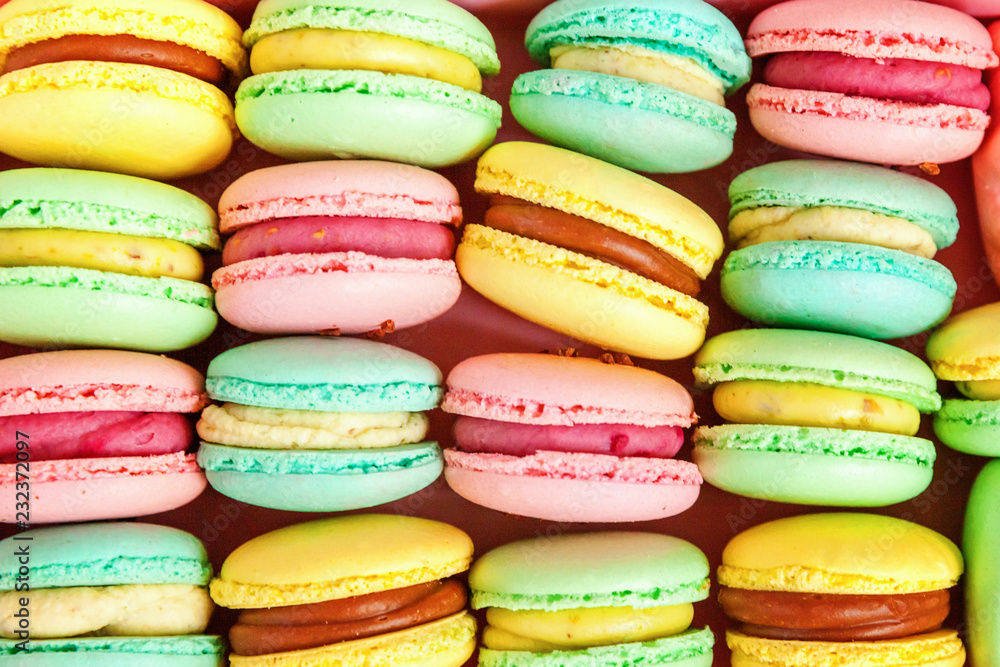 Sweet almond colorful pink, biue, yellow, green macaron or macaroon dessert cake background. French sweet cookie. Minimal food bakery concept. Flat lay, top view, copy space Sweet almond colorful pink, biue, yellow, green macaron or macaroon dessert cake background. French sweet cookie. Minimal food bakery concept. Flat lay, top view, copy space