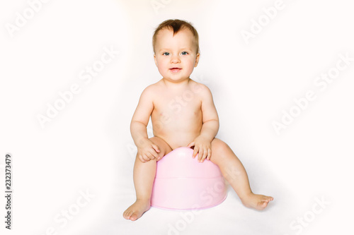 baby smiling and sitting on the potty