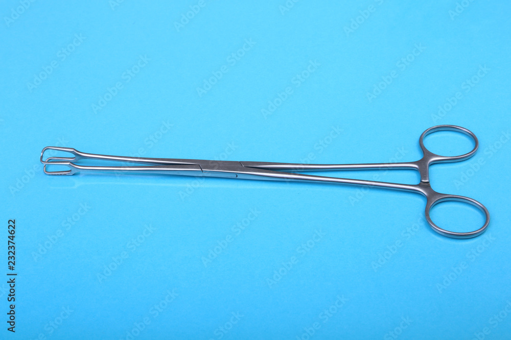 Close Up Surgical instruments and tools on blue mirror background. Selective focus. Close Up Surgical instruments and tools on blue mirror background. Selective focus.