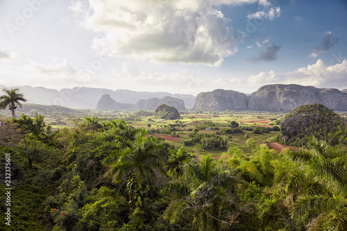 valley in Vinales, Cuba surrounded by mountains with a cloudy sky in the background