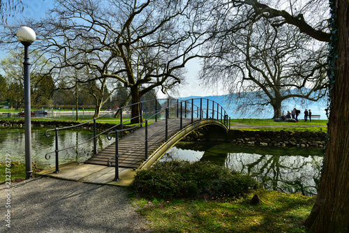 View of the arch bridge in Villette-Park on the shore of Lake Zug on a spring sunny day. Town of Cham, canton of Zug, Switzerland, Europe. photo