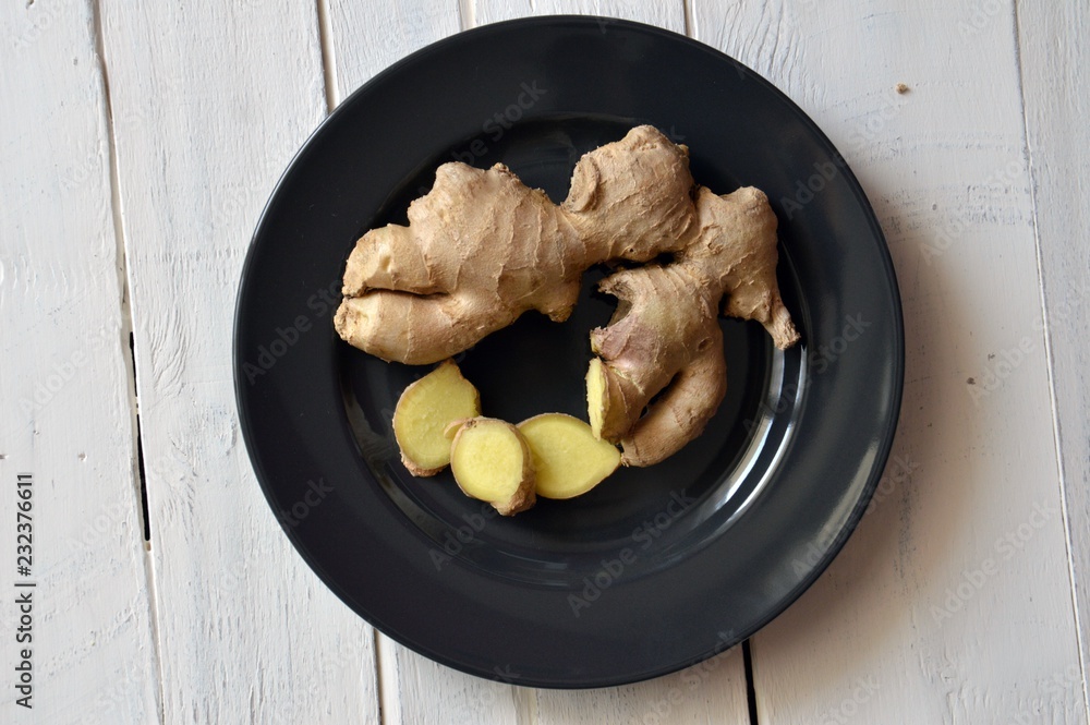 sliced ginger on black plate sliced ginger on black plate