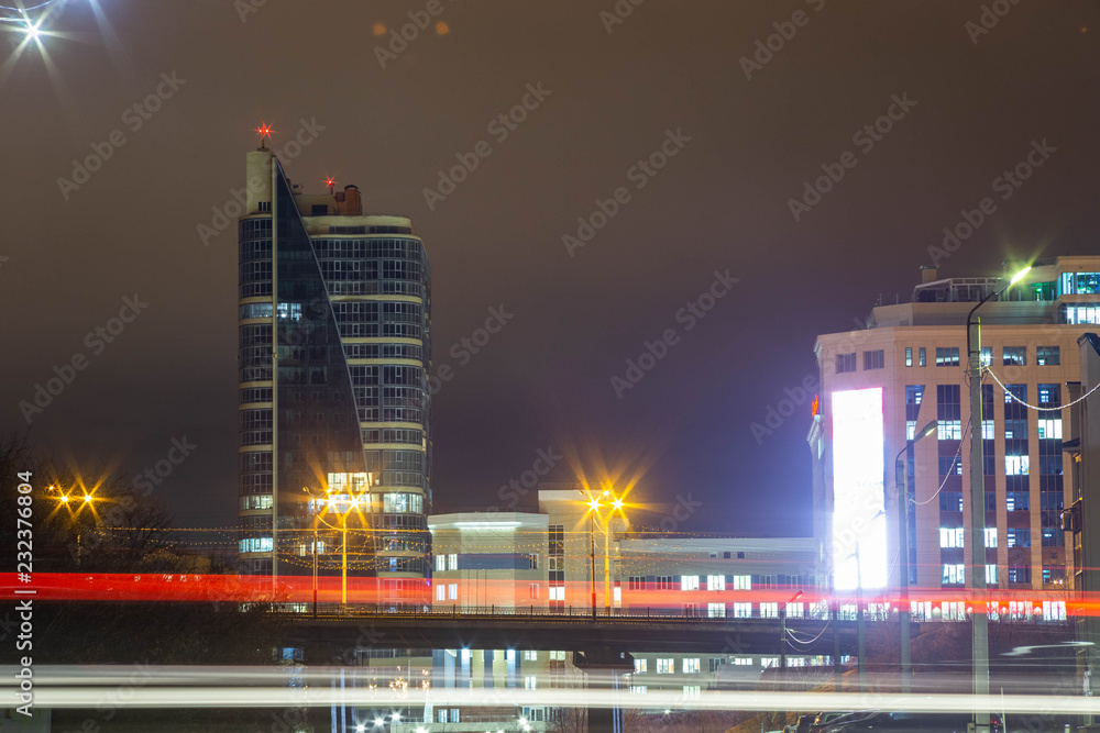 night view of the business center of the Republic in Cheboksary in Russia with a bridge in front of him and the light of passing cars