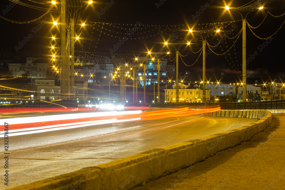 light passing cars on the bridge in Cheboksary in Russia, called the road to the temple