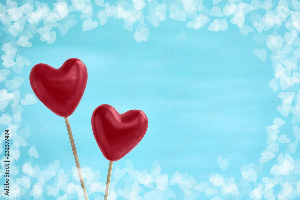 Two red hearts on blue background. Top view, copy space