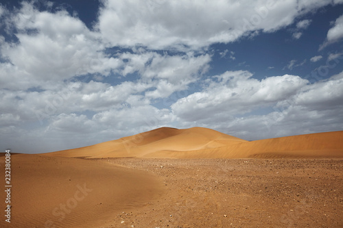 Sahara desert landscape with blue sky. Dunes background