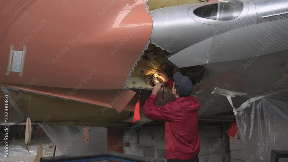 Wing Inspection Fixturing The engineer repairing the aircraft at the factory. Repair of an ...