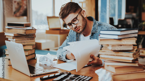 Tableau sur toile Pensive Freelance Text Writer Working at Desk