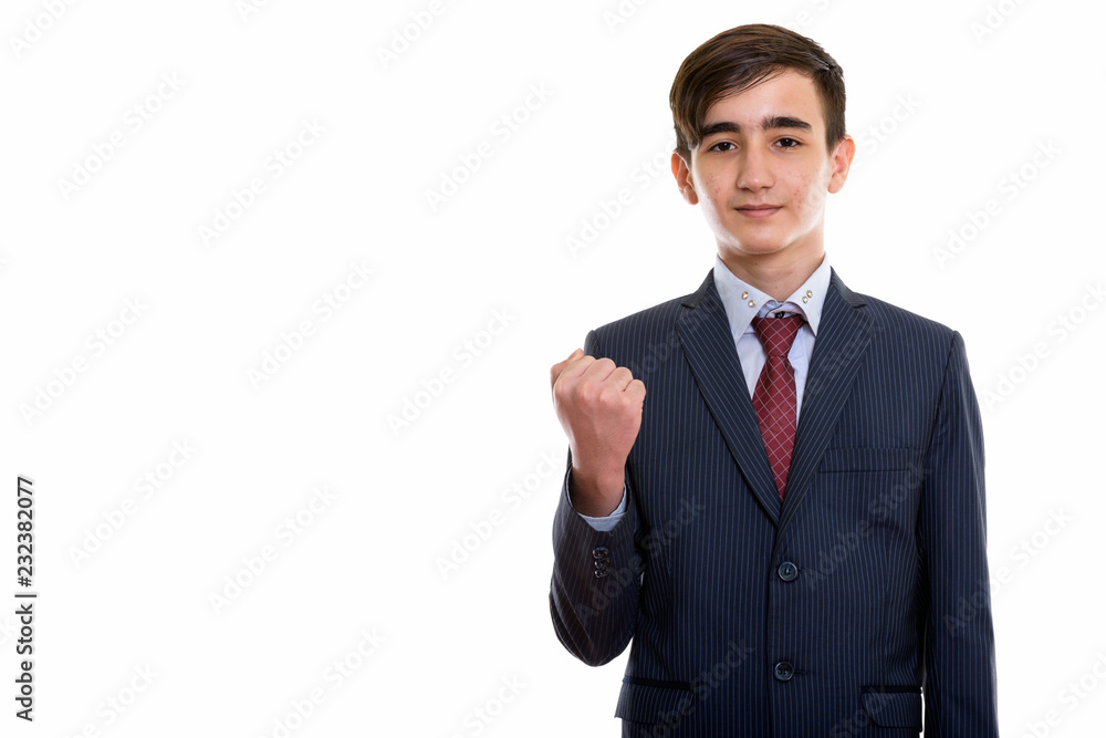 Studio shot of young handsome Persian teenage businessman lookin Studio shot of young handsome Persian teenage businessman lookin