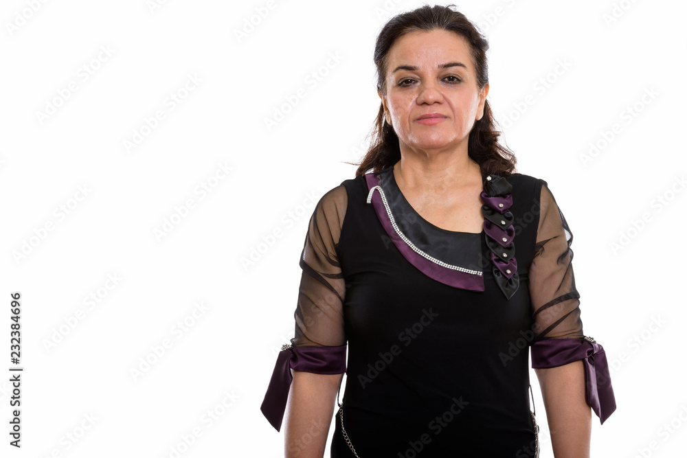Studio shot of mature Persian woman looking at camera Studio shot of mature Persian woman looking at camera