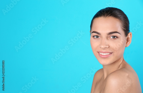 Portrait of beautiful young woman and space for text on color background. Cosmetic surgery concept