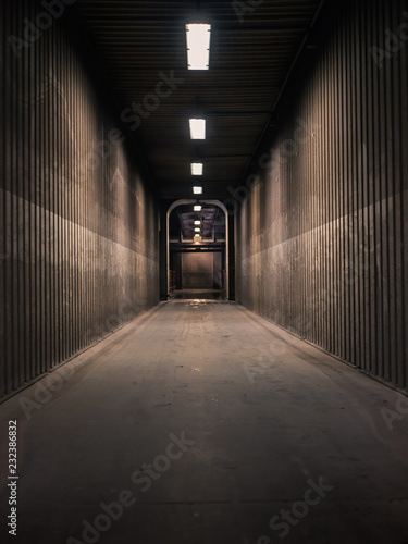 Empty hallway in a factory with neon lights shining