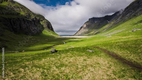 An establishing shot of the valley leading to and Horseid beach itself on a sunny summer day. Lofoten islands, Norway. photo