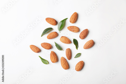 Composition with organic almond nuts on white background, top view