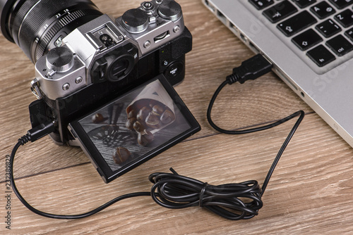 Transfer photos from camera to computer via cable.