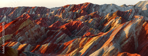 Zhangye Danxia National Geopark - Gansu Province, China. Chinese Danxia multicolor danxia landform, rainbow hills, unusual colored rocks, sandstone erosion, layers of Red, Yellow and Orange stripes. photo