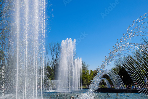 Krasnodar, Russia - May 1, 2017: City fountain in the city of Krasnodar. People are walking by the fountain. Water splashes. photo