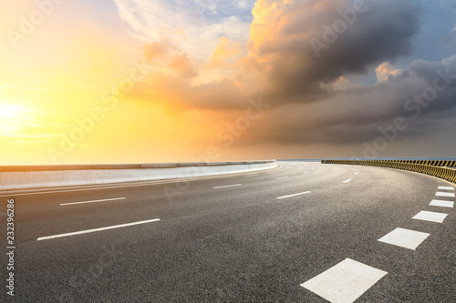 Empty asphalt road and dramatic sky at sunset © ABCDstock