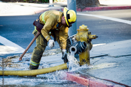 fireman disconnecting hose photo