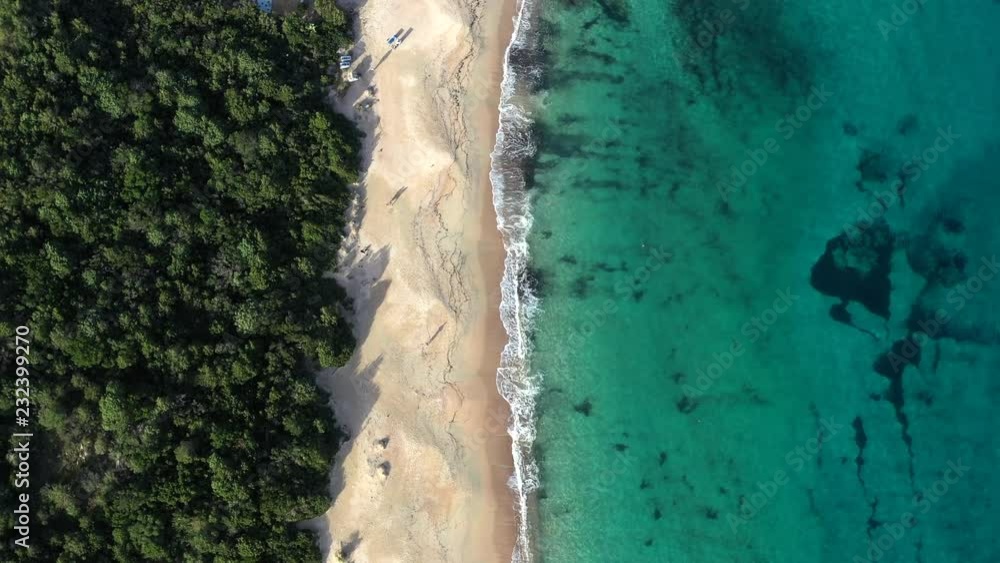 Aerial view of a green coast with a beautiful wild beach bathed by a turquoise and transparent sea. Sardinia, Italy Aerial view of a green coast with a beautiful wild beach bathed by a turquoise and transparent sea. Sardinia, Italy