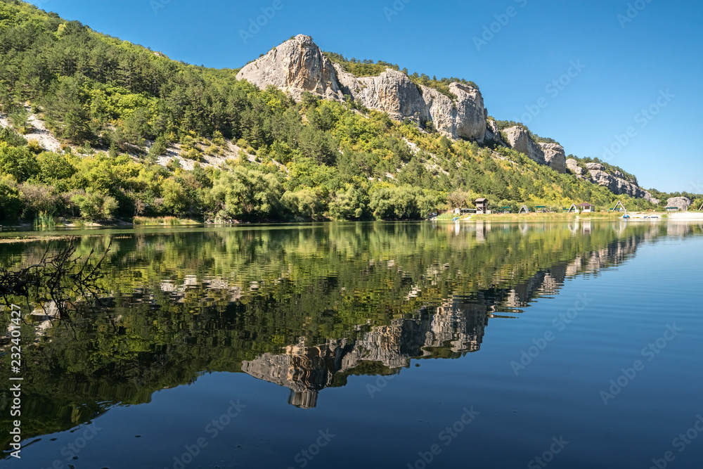 Reflection of a mountain in the lake Mangup, Crimea