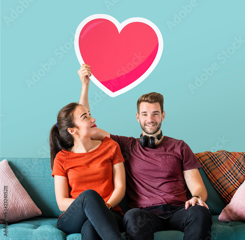 Young couple holding a heart emoticon photo