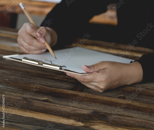 Lady holding pen, it's like a letter writer. Creative idea of work 2019 goals, writing, drawing,making notes in document.Business,investment,concept,Vintage ,Retro natural mood style. soft focus.